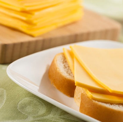 Stack of cheese slices on bread representing dairy formulation specialty