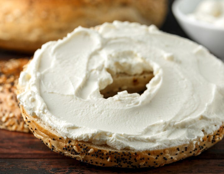 Bagel with cream cheese spread, representing plant-based dairy product development