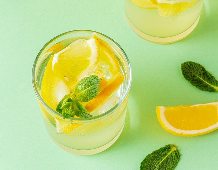 Glass of lemonade with ice and a sprig of mint, representing clean-taste sweetener solutions