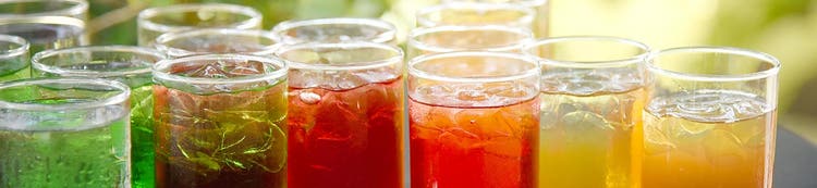 Glasses of colorful beverages, representing Ingredion beverage formulation solutions