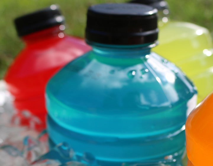 Plastic bottles of sports drinks in multiple colors, symbolizing hydration solutions