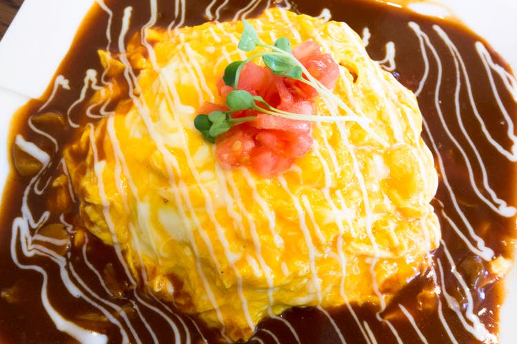 Scrambled eggs in a brown sauce, symbolizing Ingredion’s egg replacement solutions